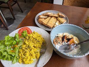 Tofu scramble with side salad, buttered toast, yogurt with granola and fresh fruit at Mela Canela - Sintra Centre in Sintra