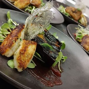 Blackened eggplant, beet puree, potato quenelles, micro greens, dill 'glass'. at Zephyr Winebar + Café in Marquette