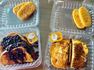 Blueberry Stuffed French Toast (left) with Hash Brown Patties (top) & Plant-based Sausage Egg & Cheese French Toast Sandwich (right) with Hash Brown Patties (top) at Lilis Vegan Breakfast - Cloud Kitchen   in Lawndale