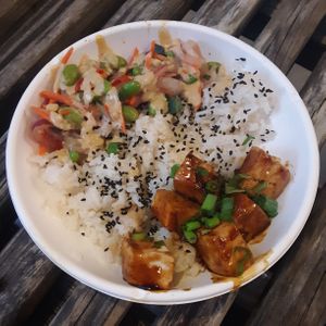Teriyaki Tofu Bowl: seasoned Jasmine rice, marinated tofu, yuzu-pickled edamame, carrots, cucumbers, & onions drizzled w/ housemade lemon-tahini-chipotle vinaigrette & sesame seeds at Walt Disney World - Backlot Express  in Lake Buena Vista