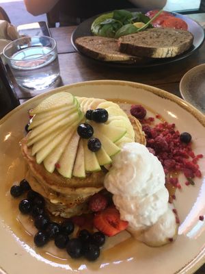 Blueberry pancakes, syrup, fruit, coconut cream   at Sweet Bones Bakery Cafe in Scullin
