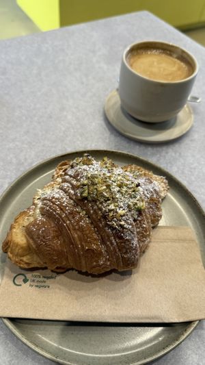 Vegan pistachio croissant and oat flat white   at Kafi - Fitzrovia in London