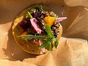 Hibiscus and Chile Arbol Infused Beetroot Tostada 

 Hibiscus and chile arbol infused Beetroot Tostada, orange Salsa Macha and rucola served on an orga at Duro De Matar in Lisbon