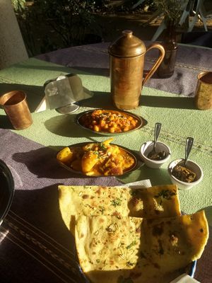 Chickpea curry, cauliflower/potato curry, pickled green mango and amla,  Naan - Indian flatbread at Marwari Indian Food in Tepoztlan