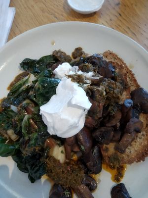 Greens and mushrooms on GF toast with coconut yogurt. at Postal Service in Auckland