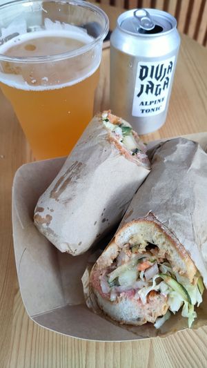 Vegan sandwich with vegan gyros meat. Draft beer from a local brewery. Local made herbal tonic at Divja Jaga in Bohinjsko Jezero