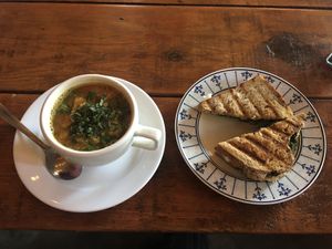Red Lentil Veggie Soup and Pesto Sandwich with melted vegan mozzarella cheese!!! at Pura Vida in Todos Santos
