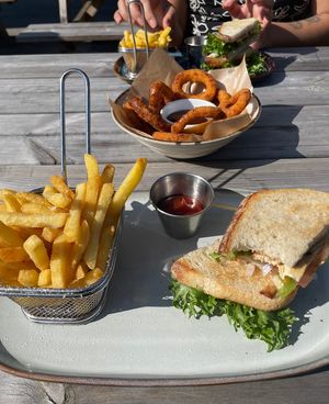 Vegan toast (levain bread, vegan ricotta, red onion, bell pepper, vegan mozzarella - fries included) / Onion rings with bbq saucee  at Alphaspel in Hagersten