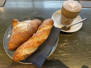 croissant, pretzel roll and flat white  at A Little Lost in Munich