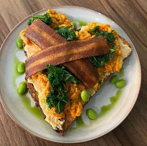Hummus on toast with vegan baconn  at Plant. Eat. Licious in Bath
