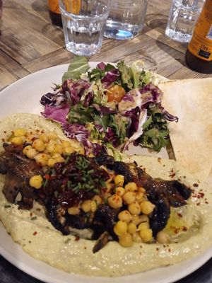 Mushroom hummus sprinkled with some chickpeas, accompanied by some pita bread and salad with unidentified vinaigrette at Karaz in Helsinki