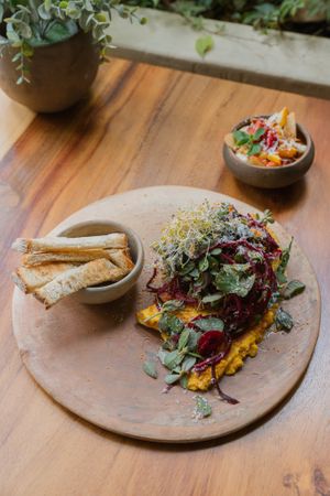 Omellete de hongos y hummus de zanahoria, acompañado de ensalada, queso parmesano y pan fresco. at Aguacate Veggie Bar in Oaxaca