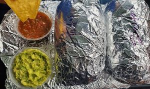 Chips, guac, salsa, tofu and seitan mixed veggie burritos at Bueno Y Sano in Acton