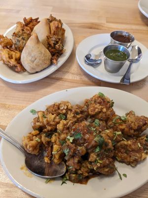 Veg appetizer platter with veg pakoda, onion pakoda, and potato samosas: Gobi Manchurian  at Aamchi Mumbai Indian Cuisine in Petoskey