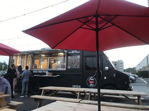 View of the pizza truck from seating area  at Josies Pizza Bar in Glen Cove