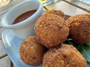 Fried arancini rice and cheese fritters with spicy tomato sauce  at goatlandia kitchen in Sebastopol