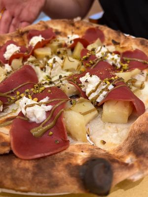 Pizza with baked potatoes, fake speck, pistacchio cream and stracciatella cheese  at Bottega di Rosaria in Siena
