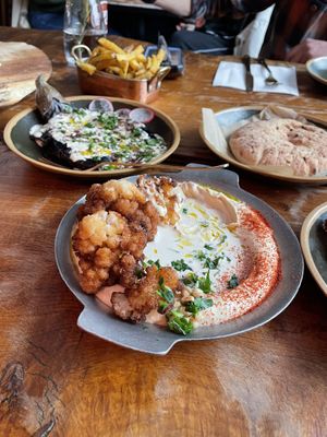 We had the smoked aubergine, hummus and fries 🍟   at Cult of Pita in Porto