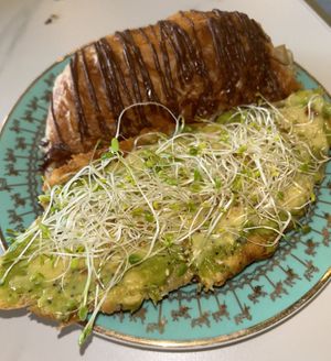 My plate held half of the croissant and half of the avocado toast. It’s very filling and generous serving sizes    at Unicorniverse Bakery & Cafe in Round Rock
