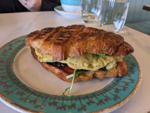 La verte sandwich (pesto, just egg, greens, cheese, tomato) at Unicorniverse Bakery & Cafe in Round Rock