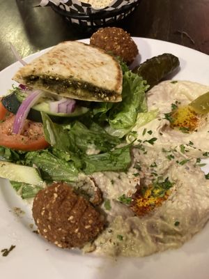 The veggie platter with hummus, baba ghannuj, za’tar pita, falafel, rolled grape leaves, and salad .  at Zayna Mediterranean in Tucson