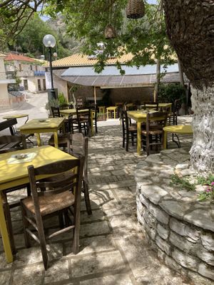 Tables under the tree  at Ta Lytrata in Lefkada