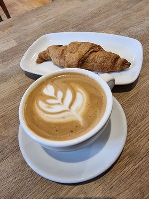Plant-mylk cappuccino and vegan chocolate croissant at Ecocafe in Budapest