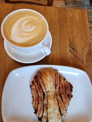 Oatmilk latte and chocolate-cinnamon bun at Ecocafe in Budapest