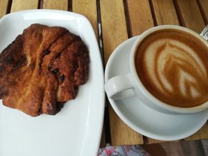 Cinnamon-chocolate bun and oatmilk cappuccino at Ecocafe in Budapest
