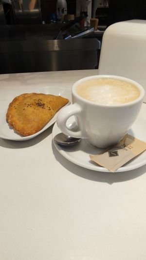 Vegan pastry (empanada) with plant-based coffee. at Paquita Degustació in Tarragona