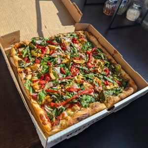 Medium VEGAN: Violife Vegan Mozzarella, Zesty Artichokes (w/ Marinated Cherry Tomatoes), Basil, Spinach, Roasted Red Peppers, Red Onions, Garlic & Tomato Sauce at Williamsburg Pizza in Omaha