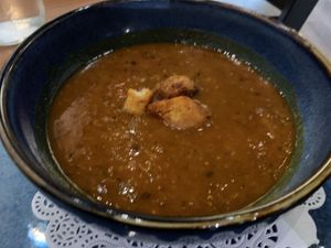 Cup of lentil soup; those croutons are likely non-vegan. I removed them and set them to the side    at Meze Moon in Chico