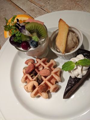 dessert plate: gluten free chocolate cake, waffle, rum raisin icecream, mousse with cream and fruit at AIN SOPH.Journey in Tokyo