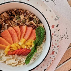 Coconut bowl (coconut milk, oats, coconut, homemade Granola, fruit) at Mya Petit Café in Funchal