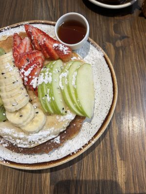Vegan pancakes with Seasonal fruit, sesame seeds and maple syrup  at Kaju in Coimbra
