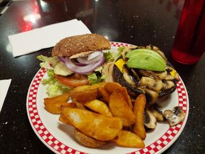 Portobello mushroom burger served with fries at Busy Bee Cafe  in Ventura