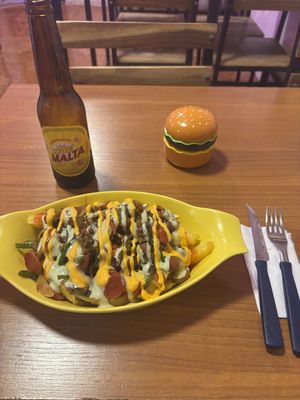 This had fried potatoes at the bottom, sauté vegetables, mushrooms and vegan sausage topped with sauces. Had a Malta to drink   at Antojitos de La Sirenita  in Puerto Ayora