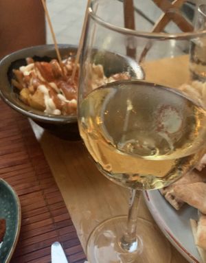patatas bravas and wine  at Green & Burger in Sant Feliu De Guixols