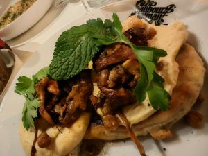 FLATBREAD, CHICKPEAS AND CHANTERELLES
SMALL BREAD
 WITH FAUBOURG KNEADED YOGURT, CHICKPEA CREAM, FRESH ROASTED CHICKPEAS
 PARSLEY, MINT AND FRIED CHANTERELLES at Faubourg Daimant in Paris