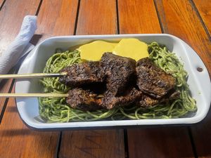 Green noodles with Anticuchos  at Oiga in Lima