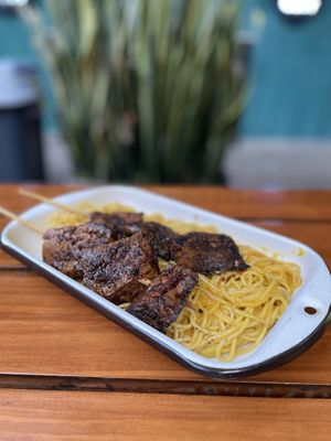 Tallarines en huancaina con anticuchos - 42 soles  at Oiga in Lima