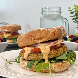 The Fabwich - patty made with heart of palm, artichoke and quinoa. Multigrain bun, arugula, onion, tomato and remoulade. at Vibrant Beat Cafe in Fort Myers