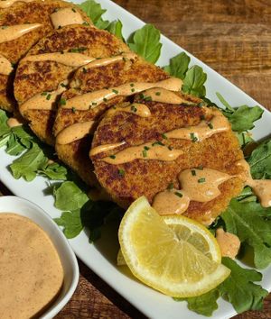 These delicious fab cake patties are seasoned to taste like a crab cake but made with artichokes, hearts of palm and quinoa. On the side is our house-made remoulade sauce.
 at Vibrant Beat Cafe in Fort Myers