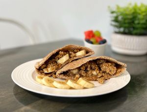 The Pecan Pita - pecan butter, banana, granola and maple syrup. at Vibrant Beat Cafe in Fort Myers