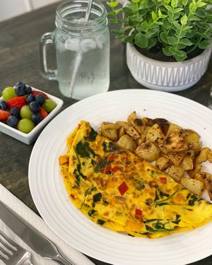 The Just An Omelette - Just egg, bell peppers, onion, spinach and side of home fries. at Vibrant Beat Cafe in Fort Myers