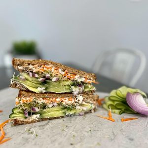 The Veg Head - toasted multigrain bread, veggie cream cheese, cucumber, sprouts, pickled onion and carrot. at Vibrant Beat Cafe in Fort Myers