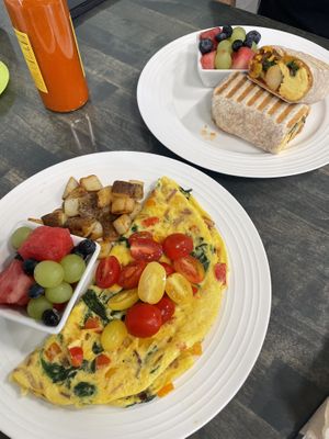 just egg vegetable omelette served with home fries and fruit & a vegan breakfast burrito   at Vibrant Beat Cafe in Fort Myers