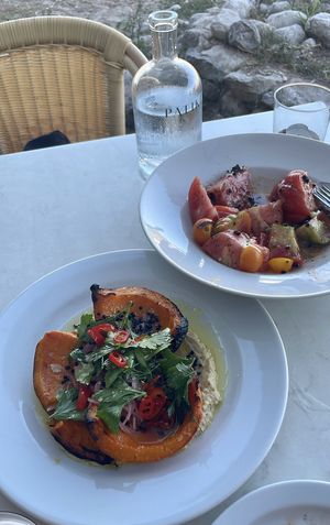 Tomato salad and charcoal toasted pumpkin with babaganoush  at Patiki Beach Bar & Kitchen in Mallorca