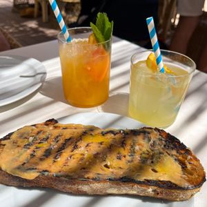 Sourdough bread with garlic spread, homemade orange lemonade and mock tail   at Patiki Beach Bar & Kitchen in Mallorca