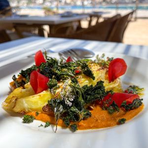 Charcoal roasted cabbage on carrot cream with kale chips  at Patiki Beach Bar & Kitchen in Mallorca